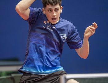 Josh Bennett plays a forehand shot