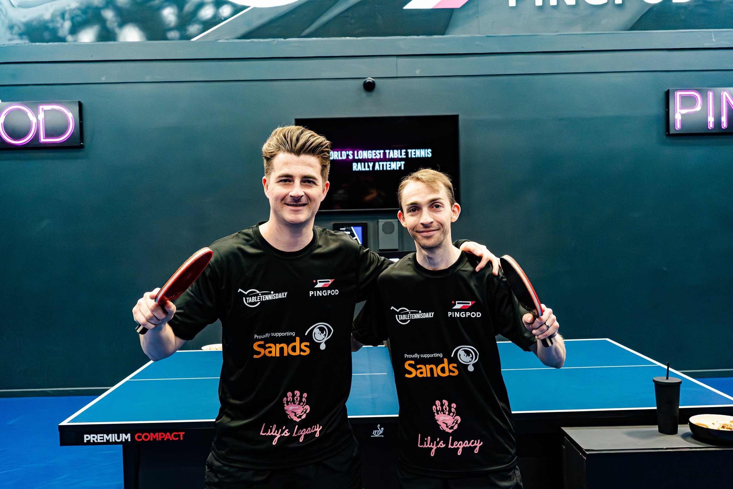 Dan and Lloyd on top of the world after breaking longest table tennis