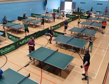 People playing table tennis in a leisure Centre