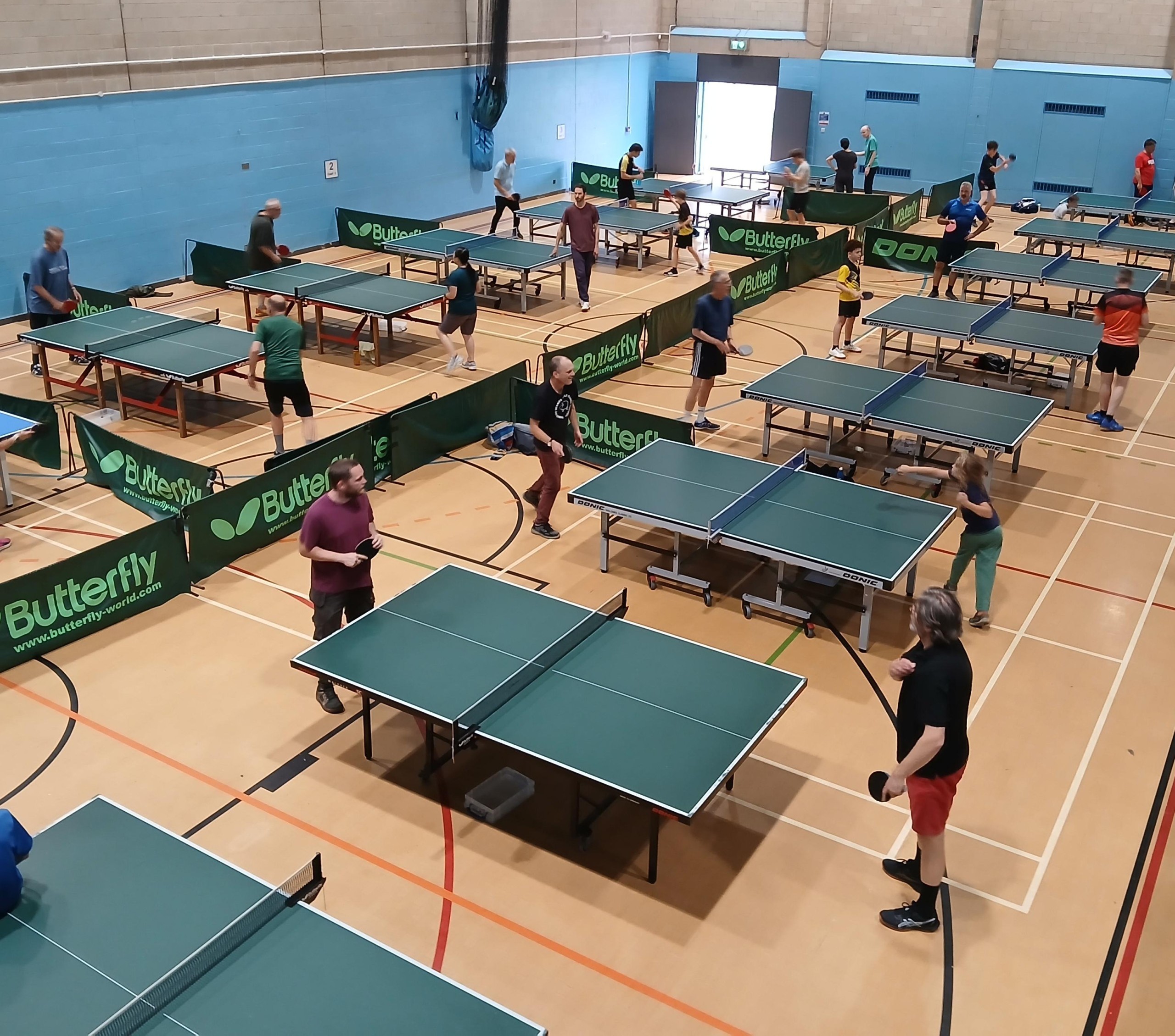People playing table tennis in a leisure Centre