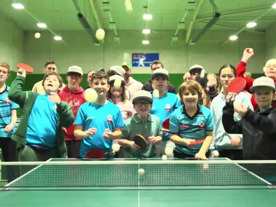 Group of children throw table tennis balls, smiling and laughing